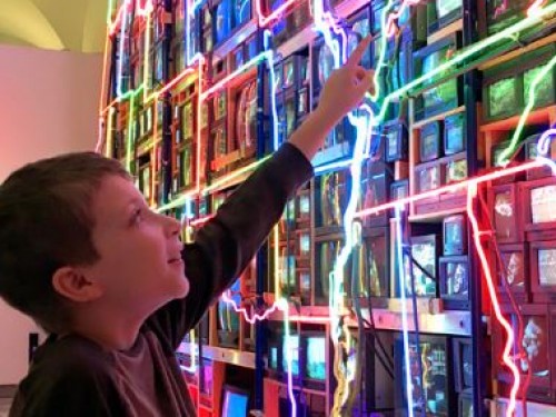 A boy looking at video art.